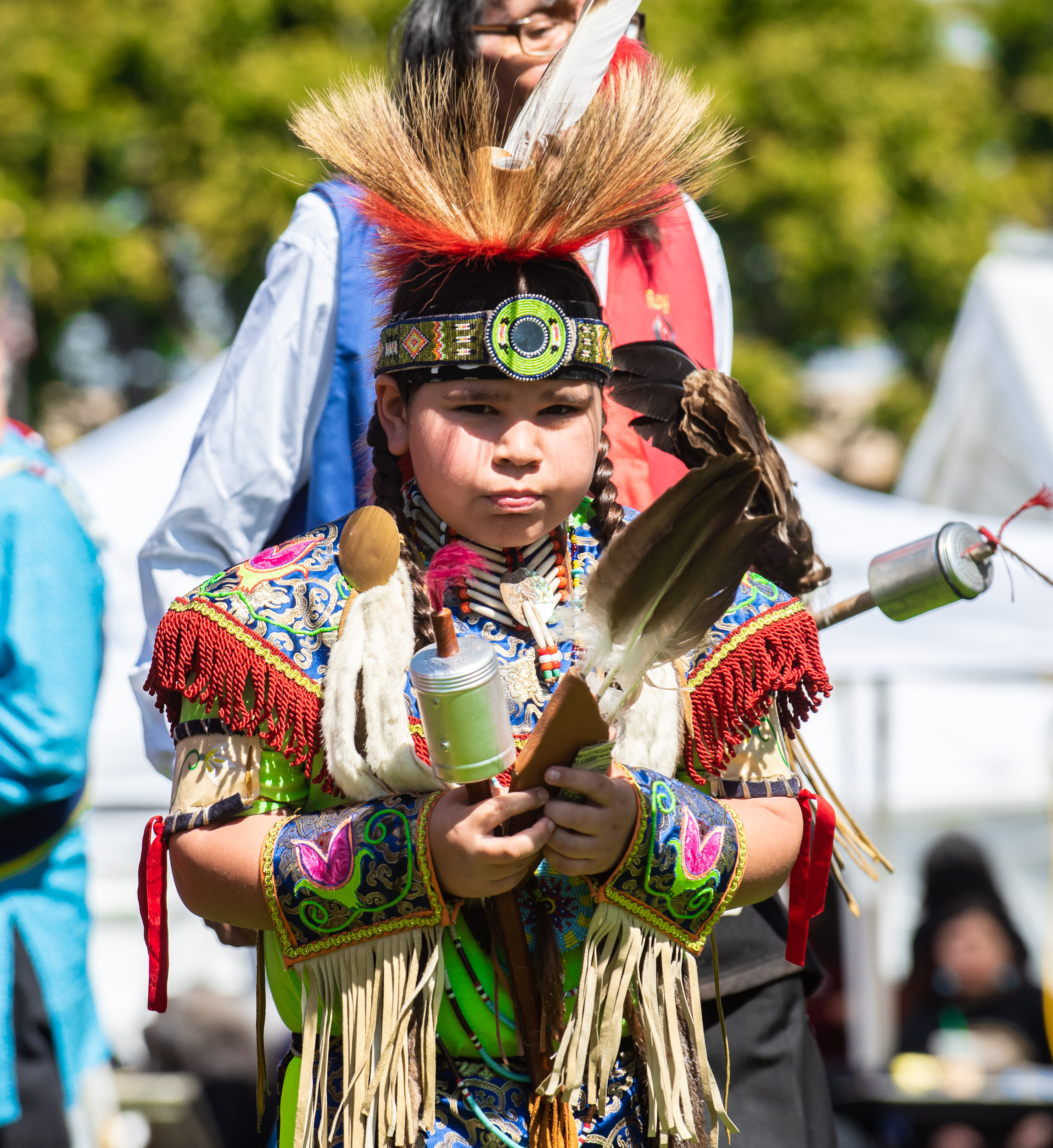 Young boy wearing Native American regalia 