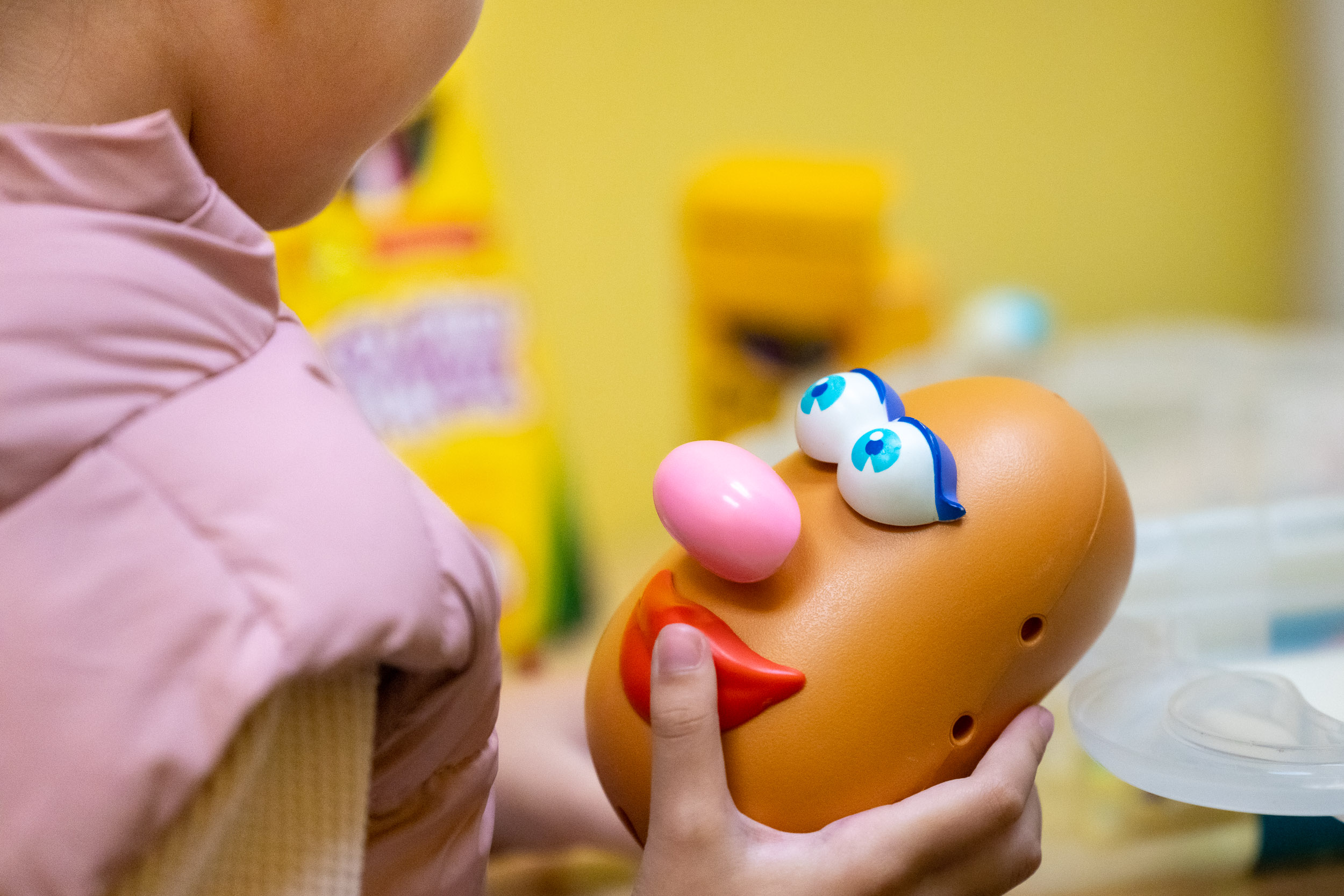 Child playing with Mr. Potato Head
