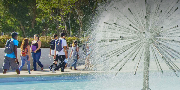 Students walking on the  campus by the Brotman Fountain