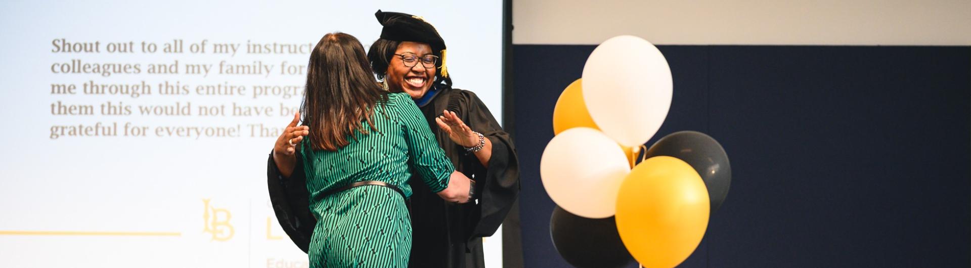 Graduate gets a hug at  Educational Administration Graduation