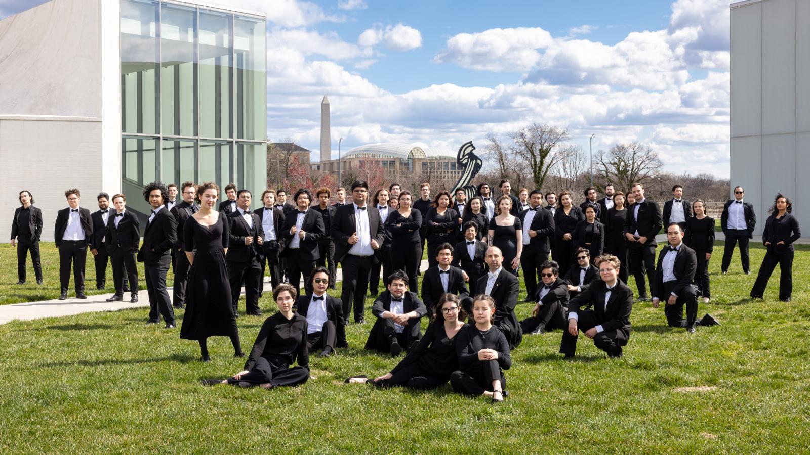  Wind Symphony Members pose on a grass lawn in Washington D.C.